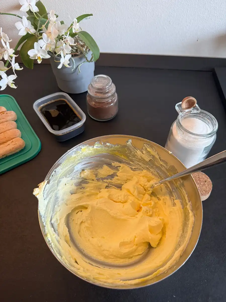 Mascarpone cheese combined with egg and sugar in a bowl.