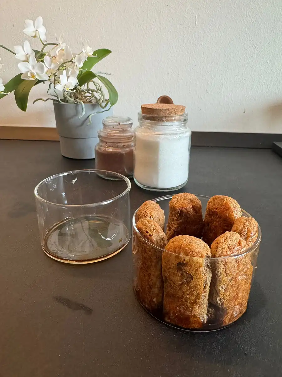 Ladyfingers arranged around the sides of the bowls for serving.